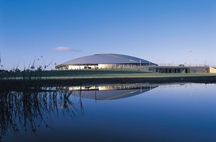 Curved light steel purlins made from GALVASPAN® steel create the Velodrome's distinctive shell-shaped roof structure. It is covered by ZINCALUME® zinc/aluminium alloy coated steel rollformed into Lysaght LONGLINE 305 sheeting in specifically tapered lengths of more than 24 metres.